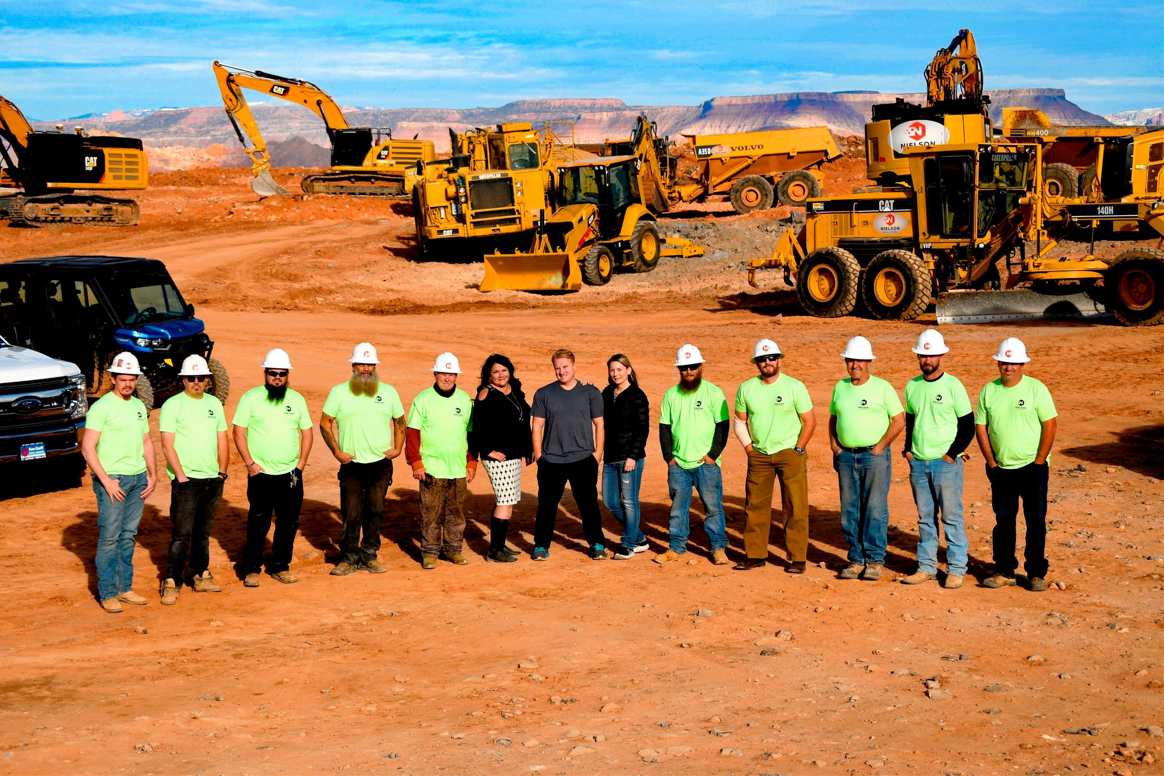 The Nielson Development crew lined up on site in front of the company equipment fleet